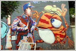 Graffiti: man and orange frog wearing a hat.  Villa Magdalenda neighborhood.  Rua Henrique Schaumann near Rua Cardeal Arcoverde.