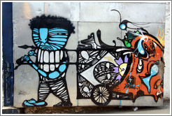 Graffiti: blue man pulling a cart.  Villa Magdalenda neighborhood.  Rua Padre Jo?Gon?ves near Rua Fradique Coutinho.