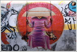 Graffiti: monk on a swing wearing a takuhatsu hat.  Villa Magdalenda neighborhood.  Rua Padre Jo?Gon?ves near Rua Fradique Coutinho.