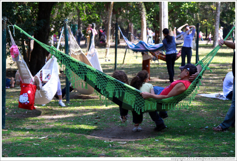 People relaxing in hammocks.  Parque do Ibirapuera.