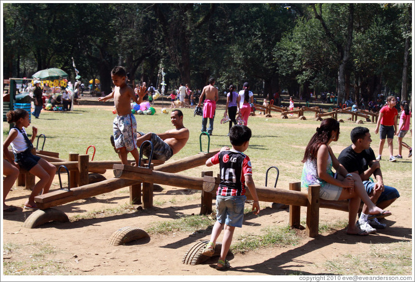 People playing on seesaws.  Parque do Ibirapuera.