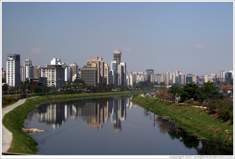 S&atilde;o Paulo skyscrapers, reflected in river.