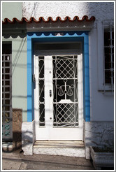 Door with a scale decoration on the screen.  Rua Artur de Azevedo.  Villa Magdalena neighborhood.