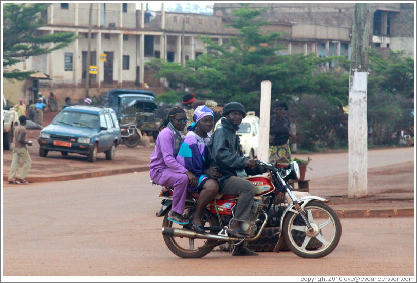 Three people riding one motorcycle.