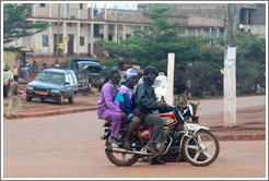Three people riding one motorcycle.