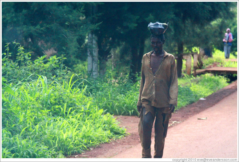 Man carrying fruit on his head.