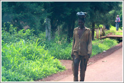 Man carrying fruit on his head.