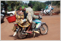 Two sets of three people riding motorcycles.