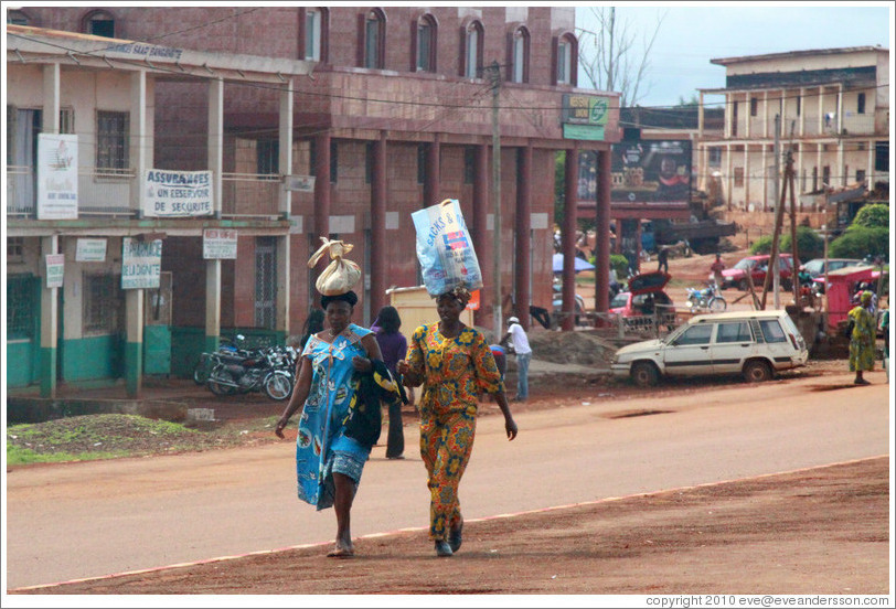 Women carrying bags on their heads.