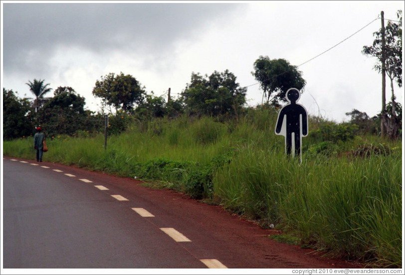 Sign depicting human figure at the side of the road.  Indicates that someone died there in a traffic accident.