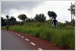 Sign depicting human figure at the side of the road.  Indicates that someone died there in a traffic accident.