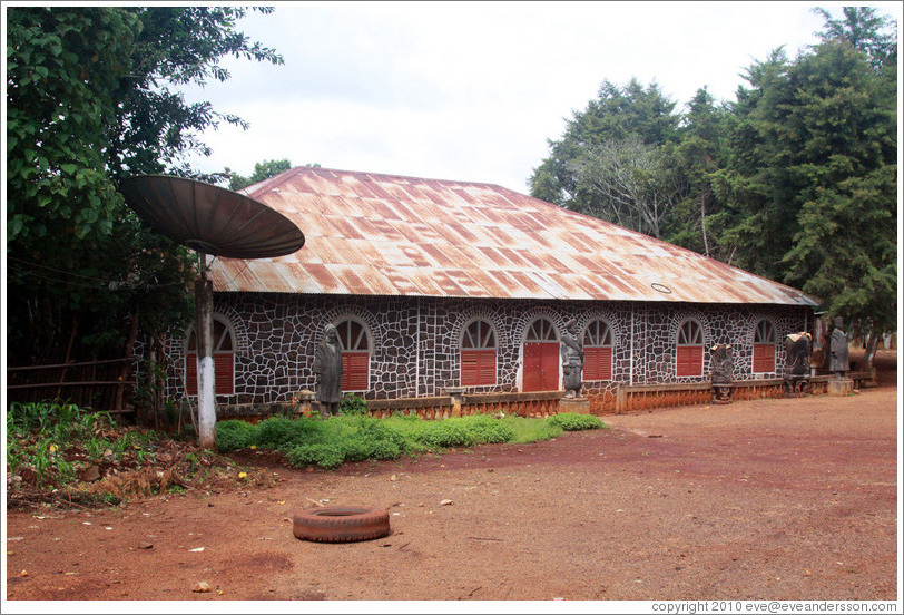 Building with satellite dish in a tribal compound.