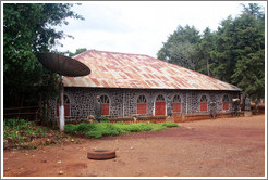 Building with satellite dish in a tribal compound.