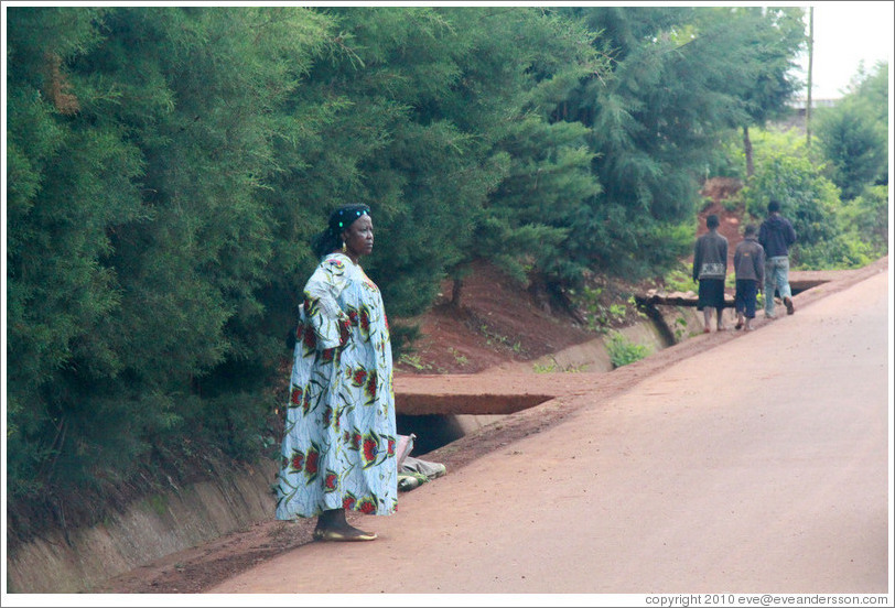 Woman at side of road.