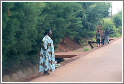 Woman at side of road.