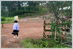 Girl carrying a bag on her head.