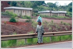 Woman carrying a bag on her head.