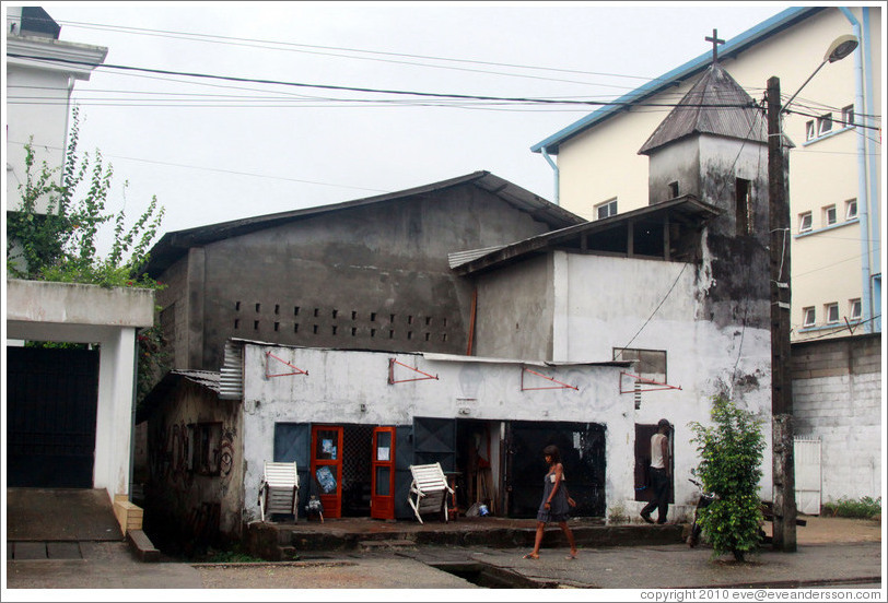 Church, with woman walking past.