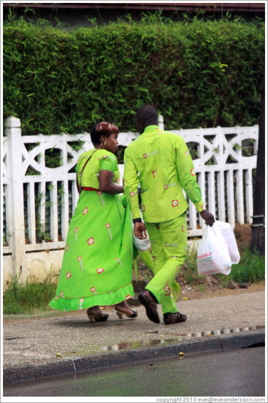 Woman and man in matching green clothing.