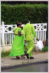 Woman and man in matching green clothing.