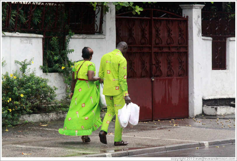 Woman and man in matching green clothing.