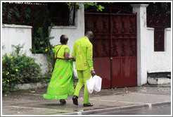 Woman and man in matching green clothing.