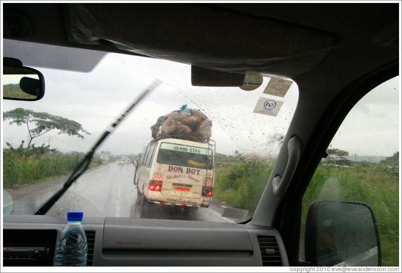 Bus loaded with cargo, on a rainy day on Route N5.