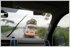 Bus loaded with cargo, on a rainy day on Route N5.