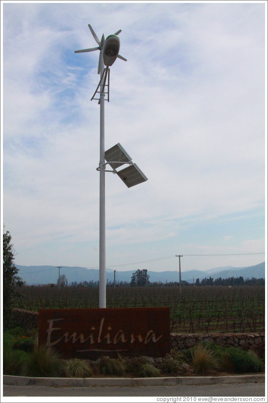 Sign, with a solar and wind powered light over it.  Emiliana Vineyards.