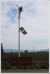 Sign, with a solar and wind powered light over it.  Emiliana Vineyards.