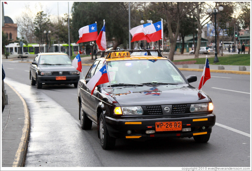 Taxi with eight Chilean flags.