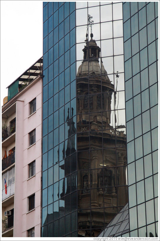 A tower of the Cathedral Metropolitana reflected in a modern building, Plaza de Armas.