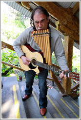 Musician playing pipes and guitar simultaneously, entertaining the funicular riders, Cerro San Crist?.
