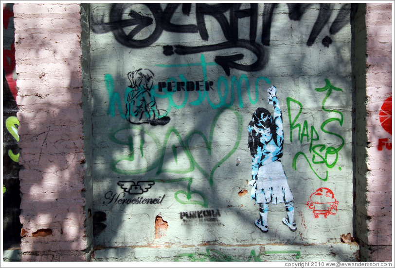 Graffiti: two girls, one of whom is creating graffiti of her own.  Santa Filomena near Ernesto Pinto Lagarrigue, Bellavista neighborhood.