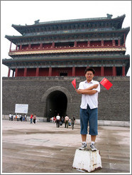 Young man holding Chinese flags (he was posing for me).  Tiananmen Square.