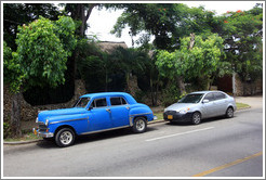 Old, blue car, with grey Hyundai.