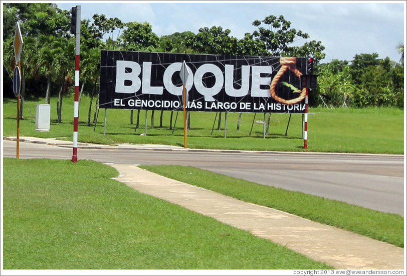 A sign near the airport reading, "Bloque. El genocidio más large de la historia." This refers to the United States' trade embargo against Cuba, saying it's the longest genocide in history.