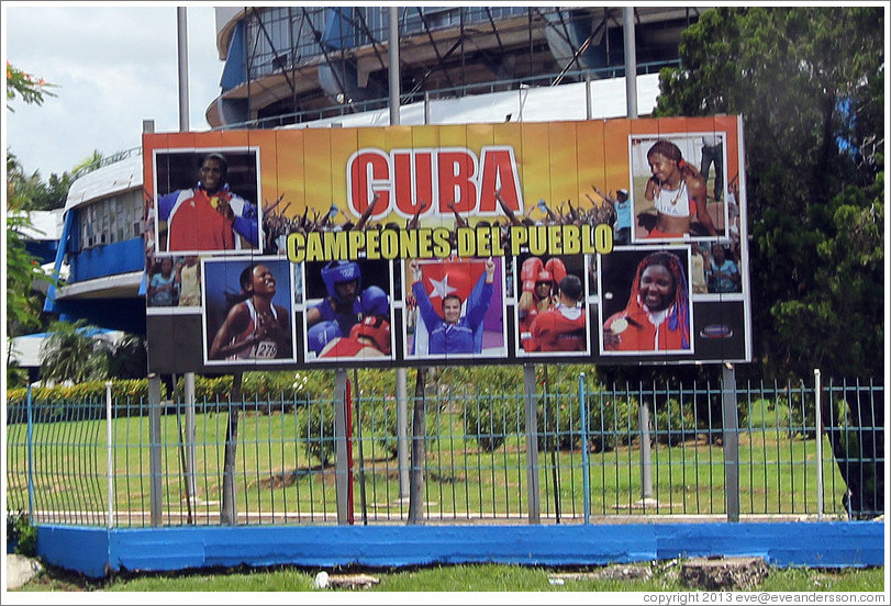 Billboard in front of the Coliseo de la Ciudad Deportiva sporting arena: "Cuba campeones del pueblo" ("champions of the people").
