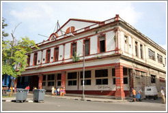 Red and white building, corner of Avenida Salvador Allende (Carlos III) and Calle Subirana.