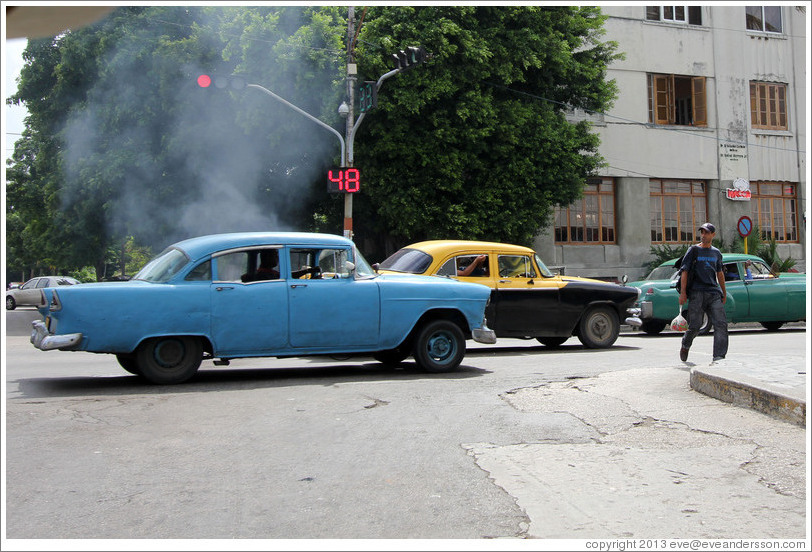 Blue car, smoking, corner of 25th Street and L Street.