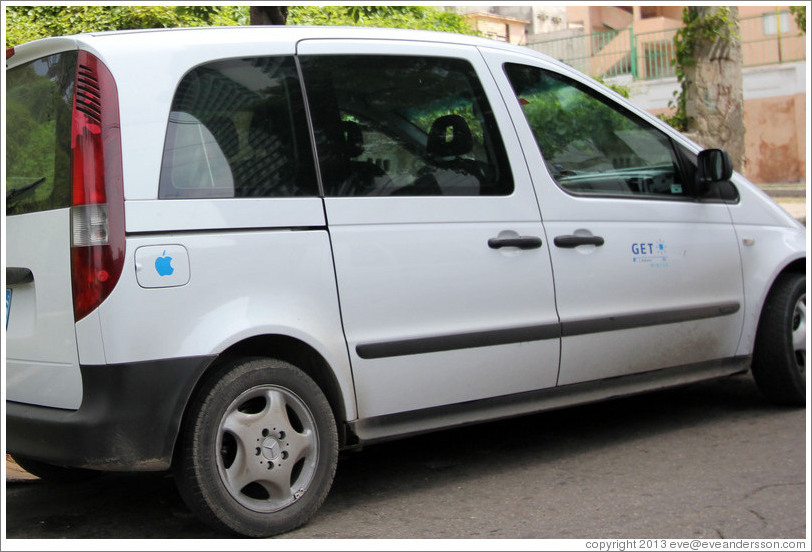 Minivan with the Apple logo on its gas tank, 25th Street.