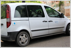 Minivan with the Apple logo on its gas tank, 25th Street.