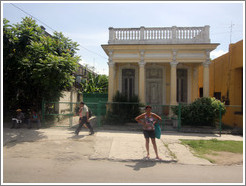 Woman in front of a yellow building, Calzada 10 de Octubre.