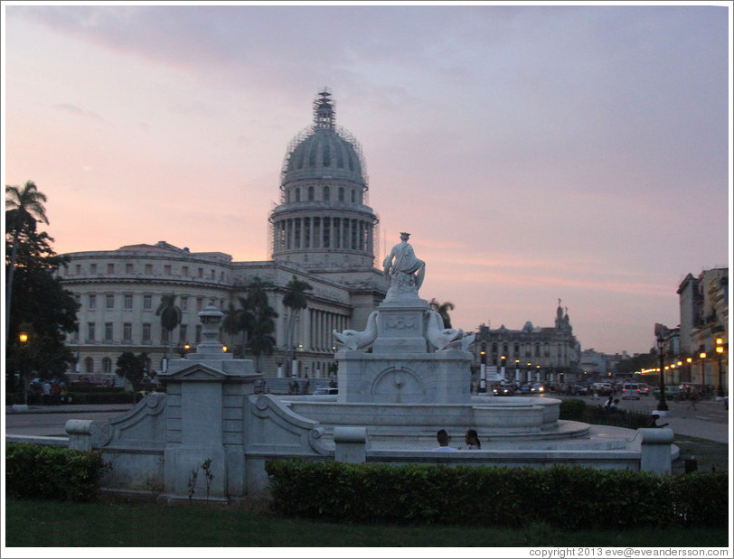 El Capitolio and a fountain at dusk.