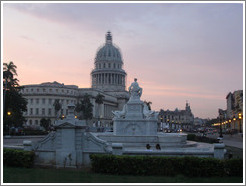 El Capitolio and a fountain at dusk.