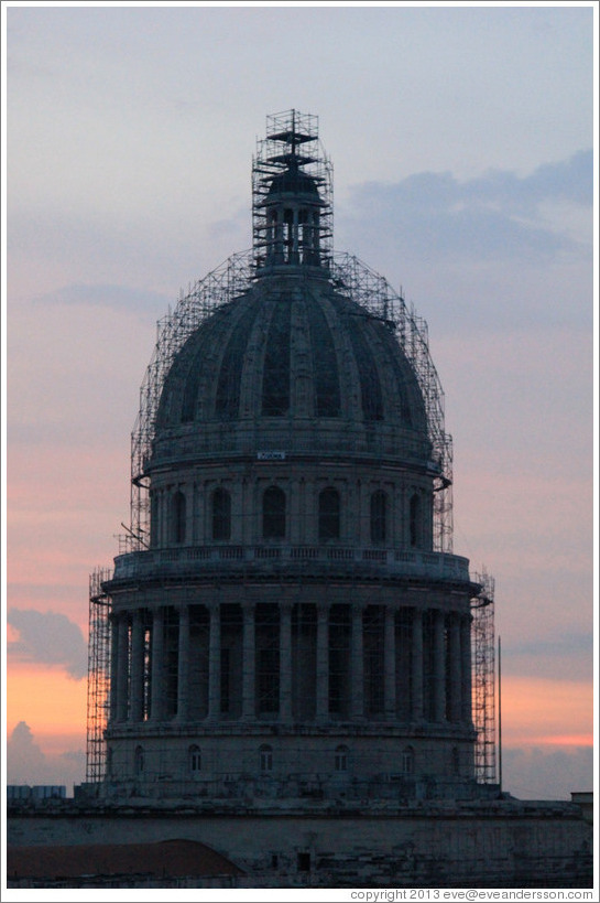 Scaffolding around the cupola of El Capitolio at dusk, seen from the rooftop of Hotel Saratoga.