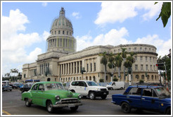 Green, blue and white cars in front of El Capitolio.