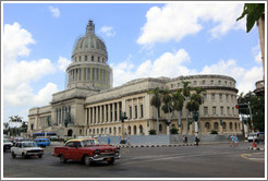 Red car in front of El Capitolio.