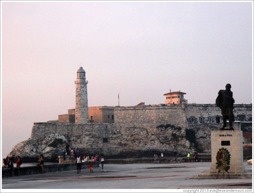 Morro Castle (Castillo de los Tres Reyes del Morro) with a statue of Miranda at dusk.