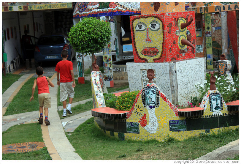 Two boys, and red block with yellow face, Fusterlandia.